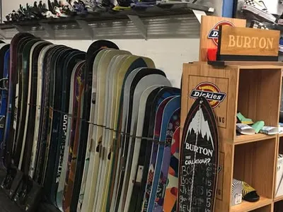 Inside Boardgarden: our real snowboard display wall and tuning shop rack