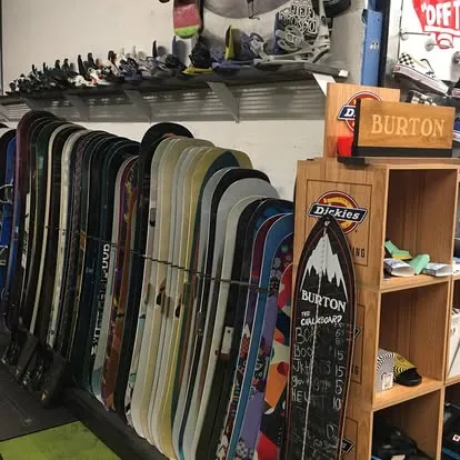 Inside Boardgarden: our real snowboard display wall and rental selection